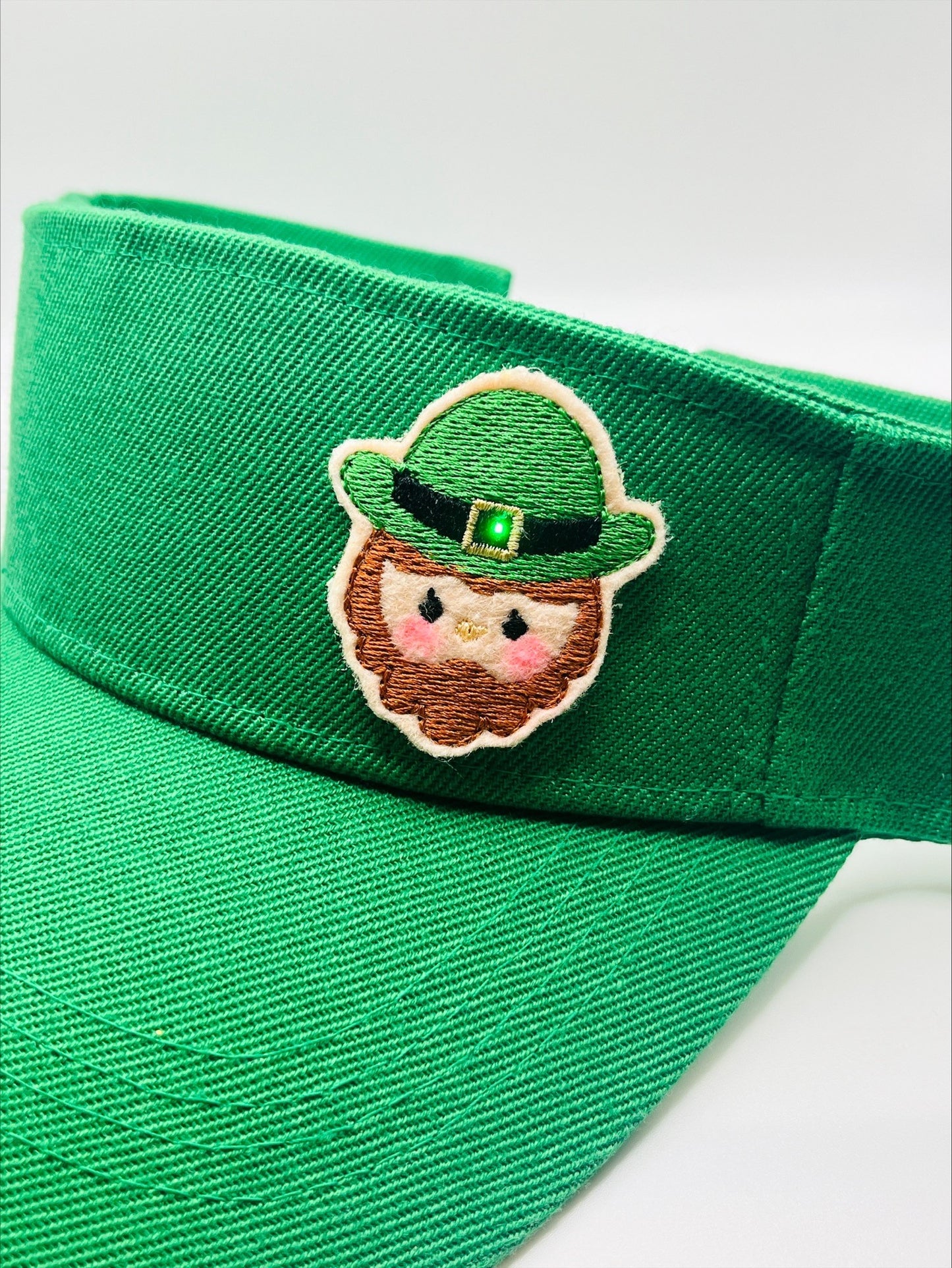 Visor With An Illuminated Buckle On A "Leprechaun" Patch